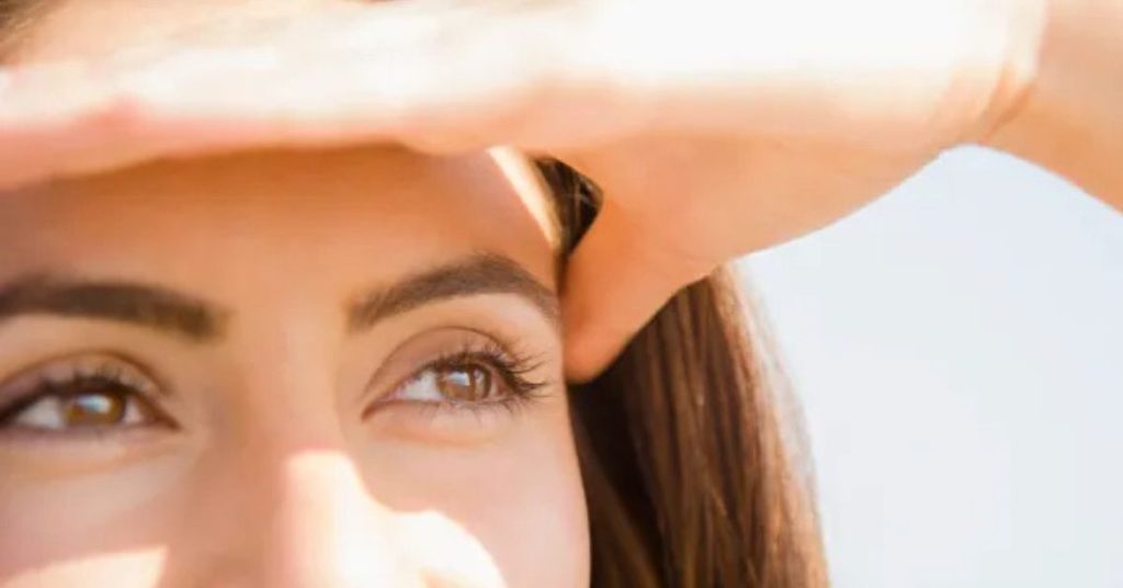 hiding face from sun