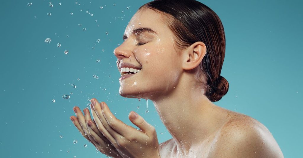 happy lady washing face after cream